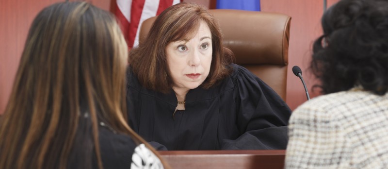 Female judge listening to two female lawyers