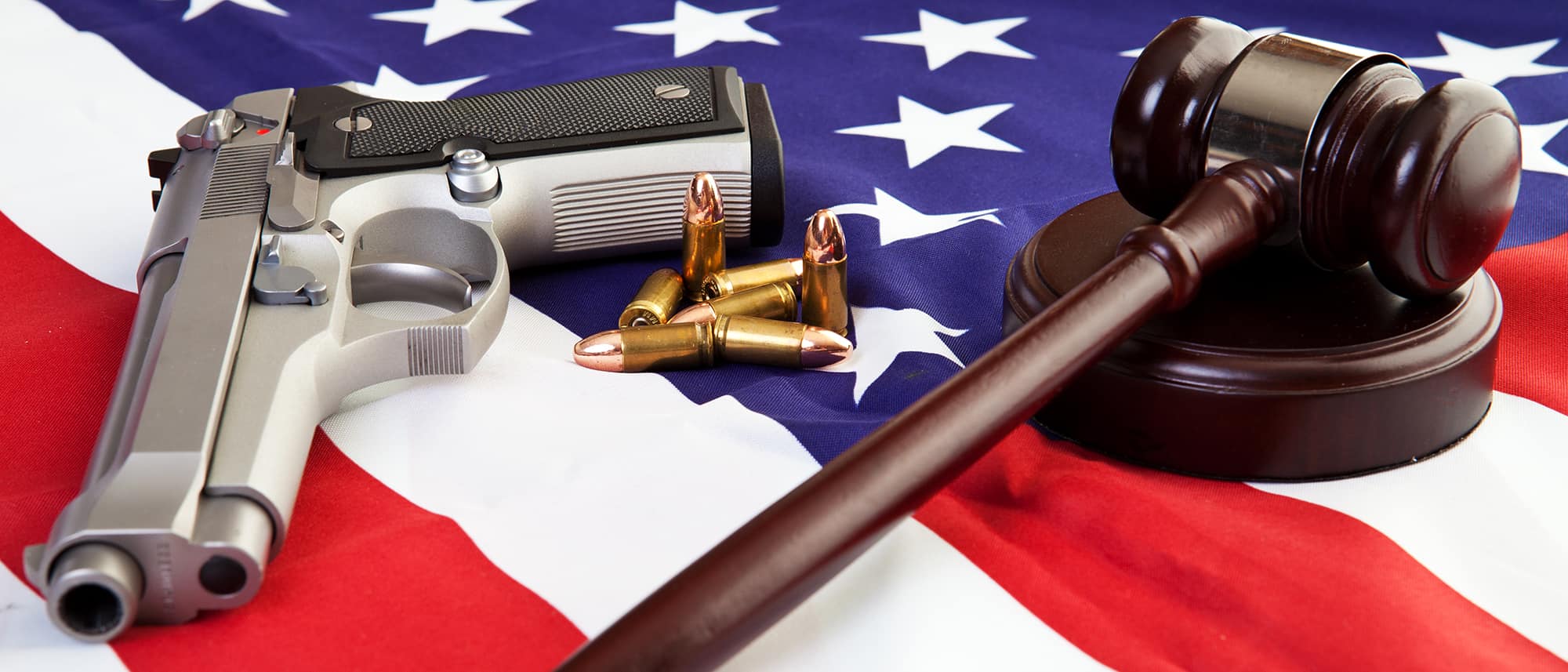 Gun, bullets, and gavel on American flag