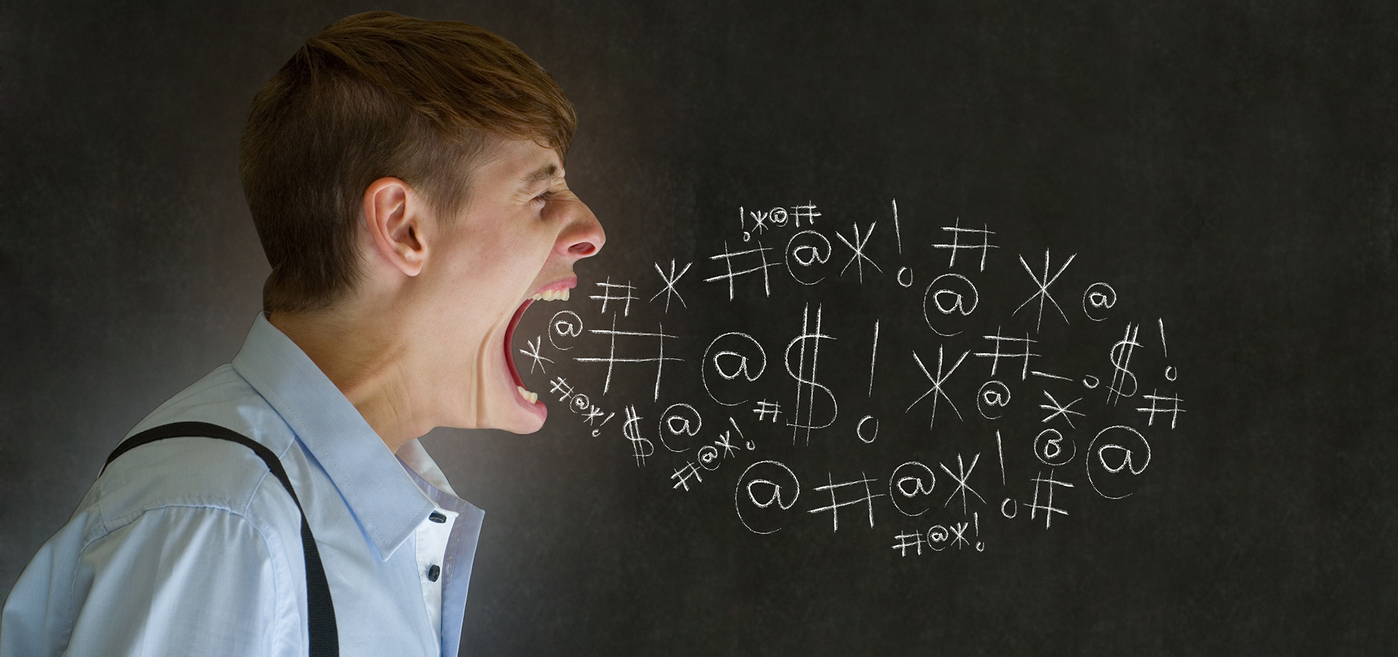 Man teacher, salesman, student or businessman angry, shouting and swearing with chalk blackboard background